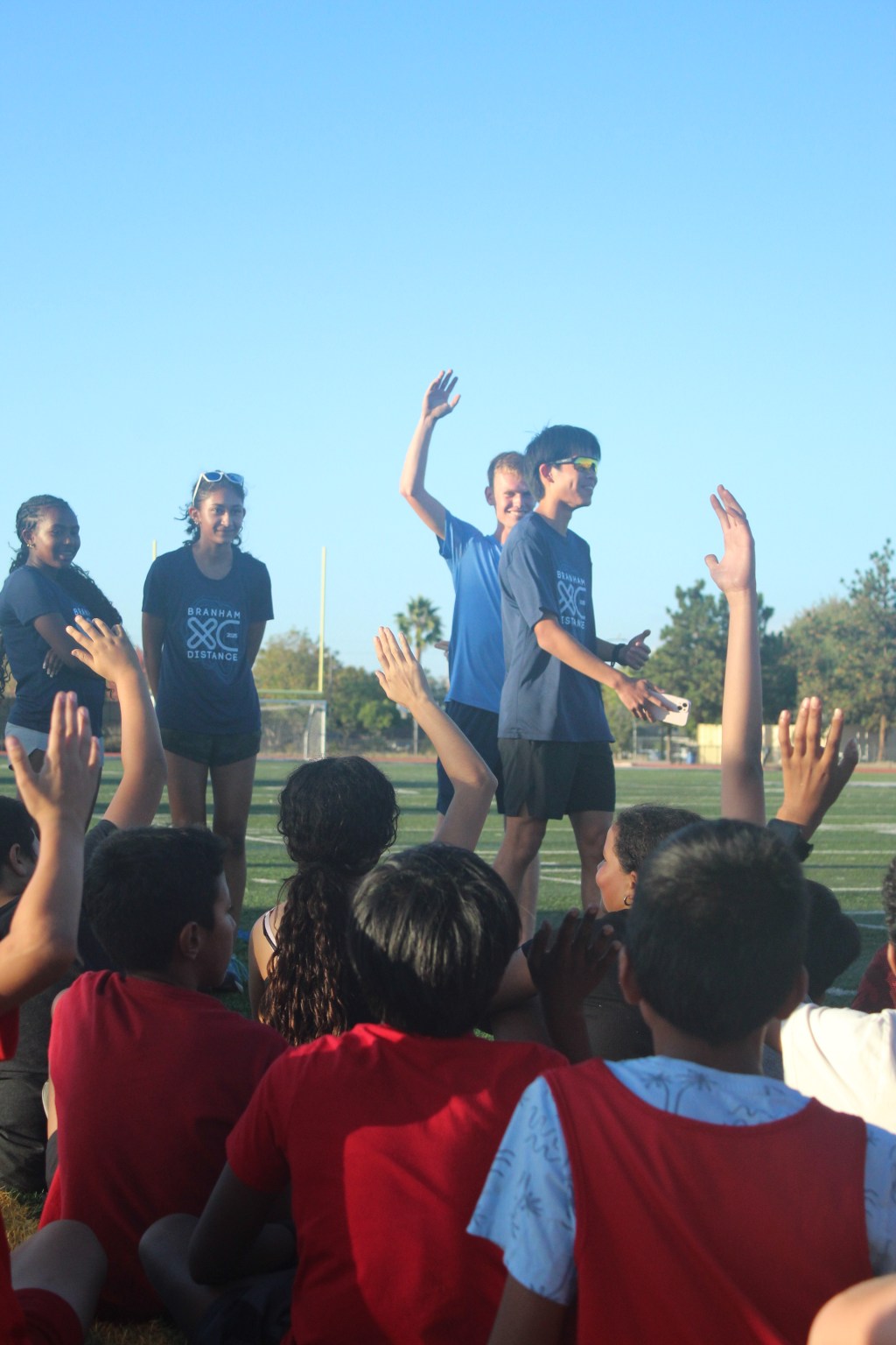 Varsity cross country athletes Amen Fekadeselassie, Asha Kumar, Daniel Cheyer, and Aaron Tsai (12) lead a joint practice with middle schoolers as a Bruins United community outreach effort.